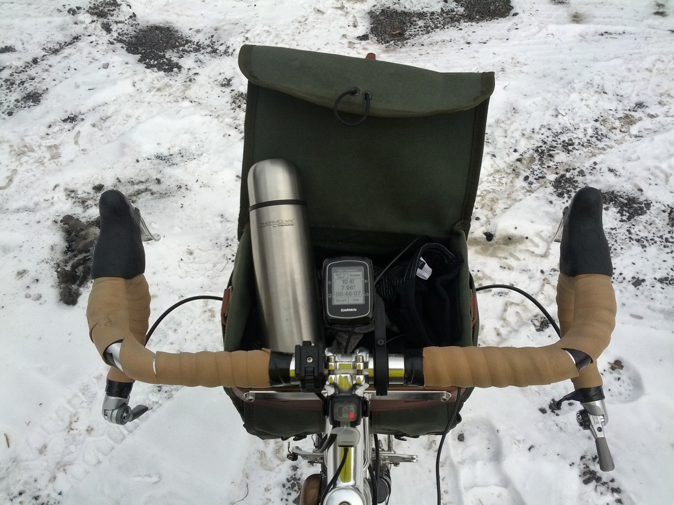 The cockpit of the Cross-Check.  Thermos of hot coffee in the handlebar bag.